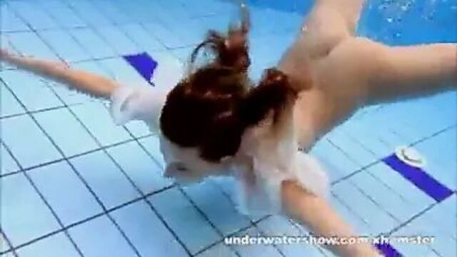 Cute Zuzanna is swimming nude in the pool